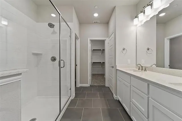 a bathroom with a double vanity sink and a mirror
