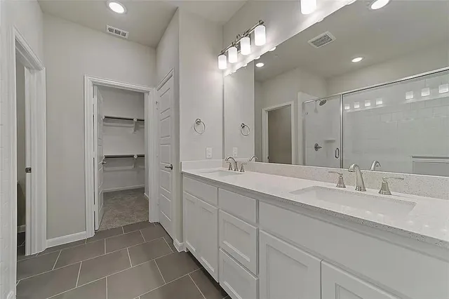 an empty room with chandelier fan