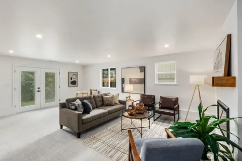a living room with furniture and a potted plant on table