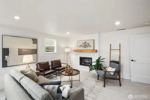 a living room with furniture a rug and a fireplace