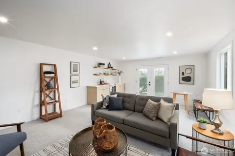 a living room with furniture and a gym machine with the view