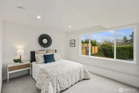 a bed room with a bed and a large window