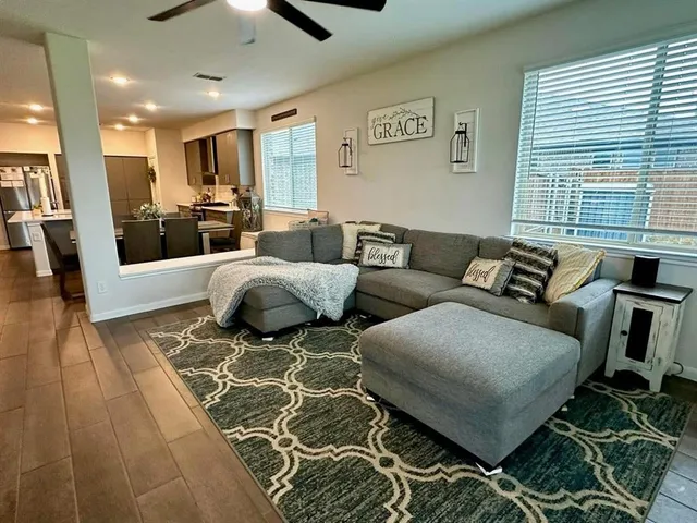 a living room with furniture and wooden floor