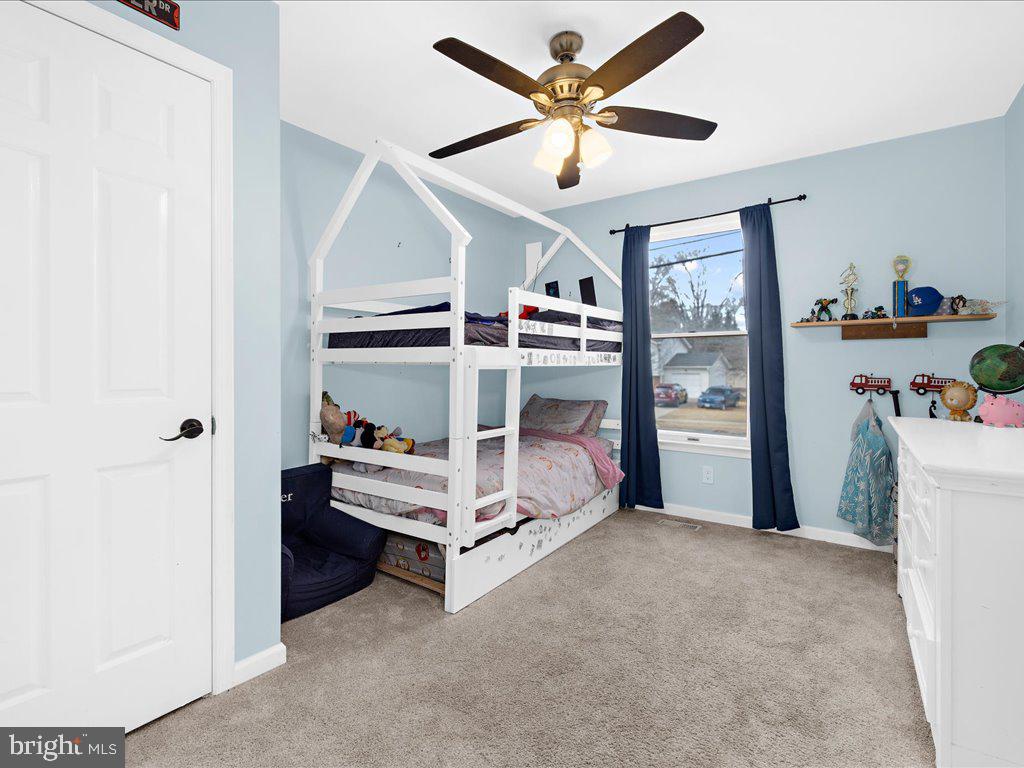 251 Ullman Road Pasadena, MD 21122 - Photo 14 of 29 a bed room with furniture and a ceiling fan