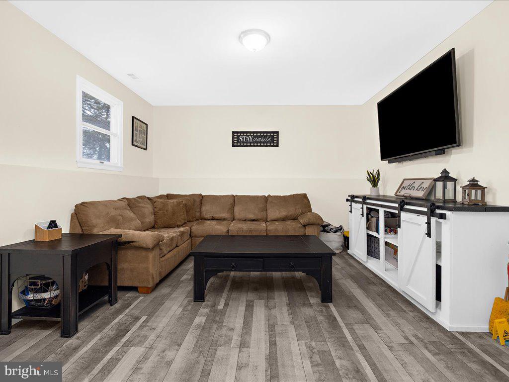 251 Ullman Road Pasadena, MD 21122 - Photo 20 of 29 a living room with furniture and a flat screen tv