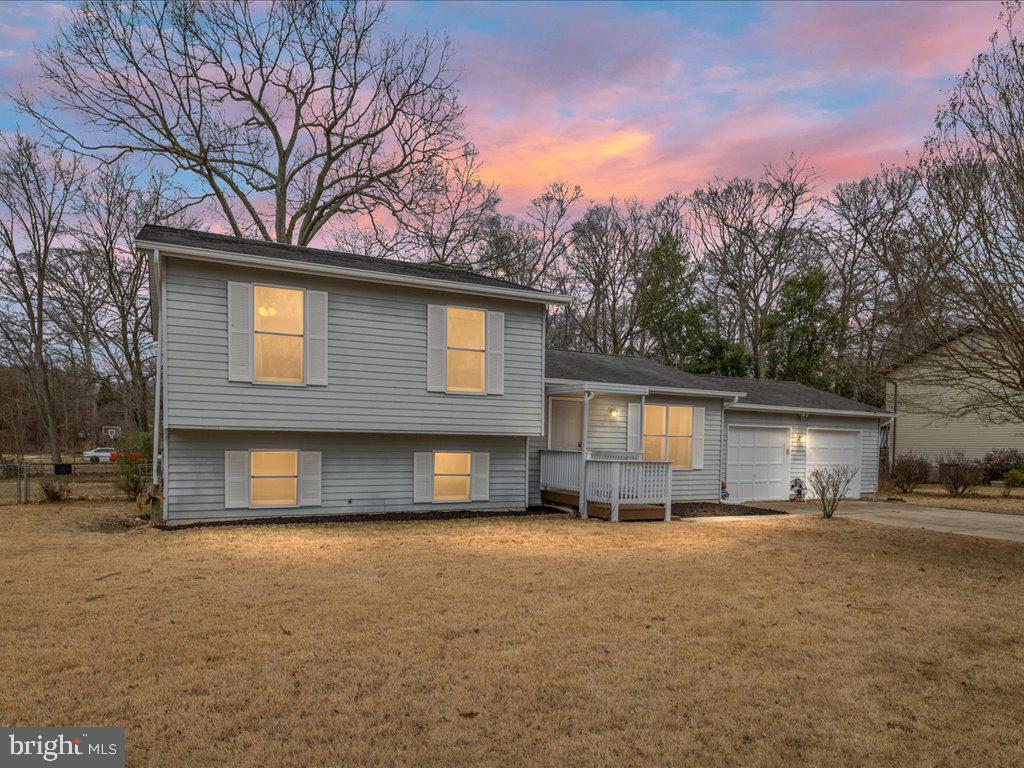251 Ullman Road Pasadena, MD 21122 - Photo 2 of 29 a front view of a house with a yard and garage
