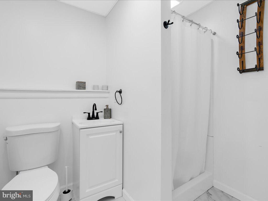 251 Ullman Road Pasadena, MD 21122 - Photo 22 of 29 a bathroom with a sink a toilet and shower