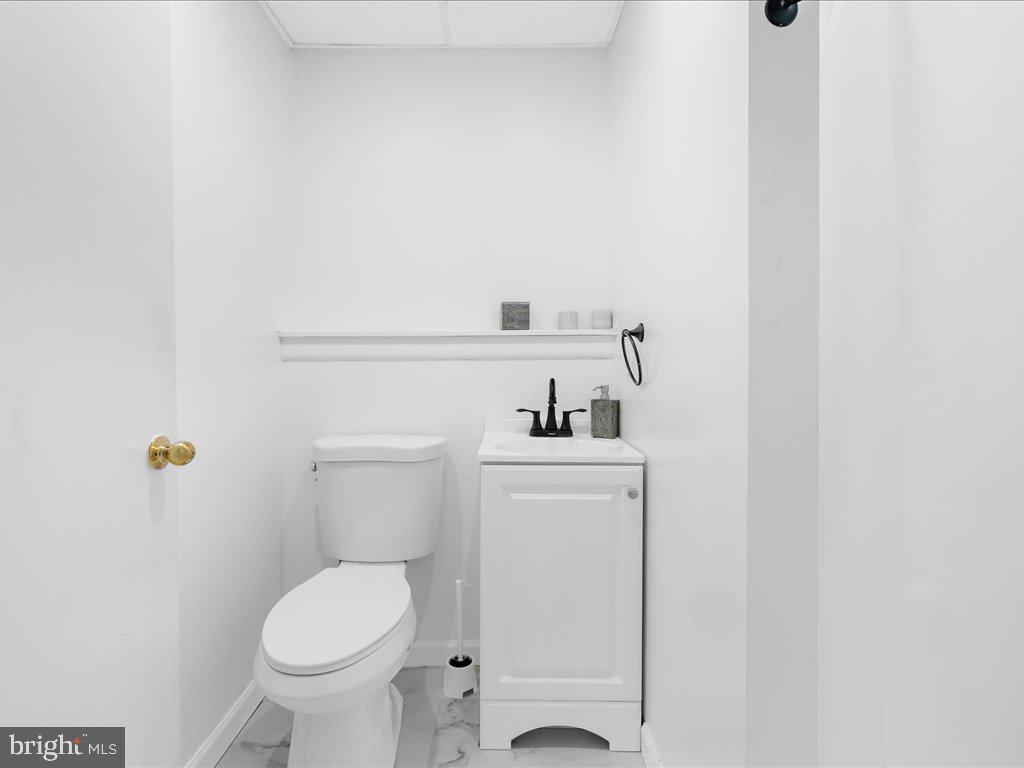 251 Ullman Road Pasadena, MD 21122 - Photo 23 of 29 a bathroom with a toilet and a sink