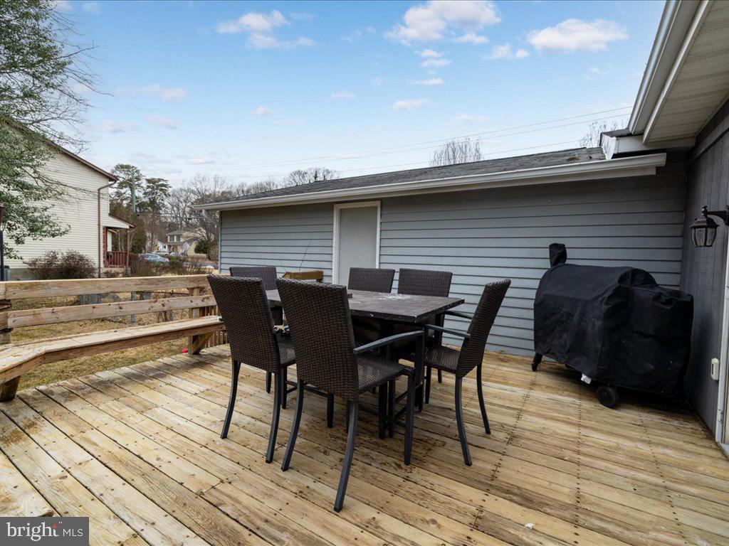 251 Ullman Road Pasadena, MD 21122 - Photo 24 of 29 a view of dinning table and chairs on deck with wooden floor