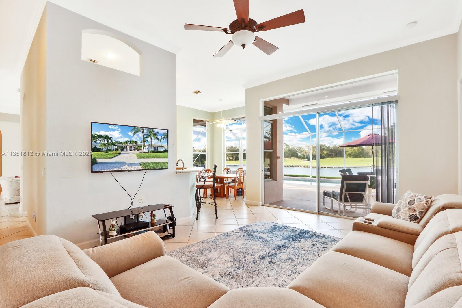 1237 Southwest Blue Stem Way Stuart, FL 34997 - Photo 22 of 48 a living room with furniture and a large window