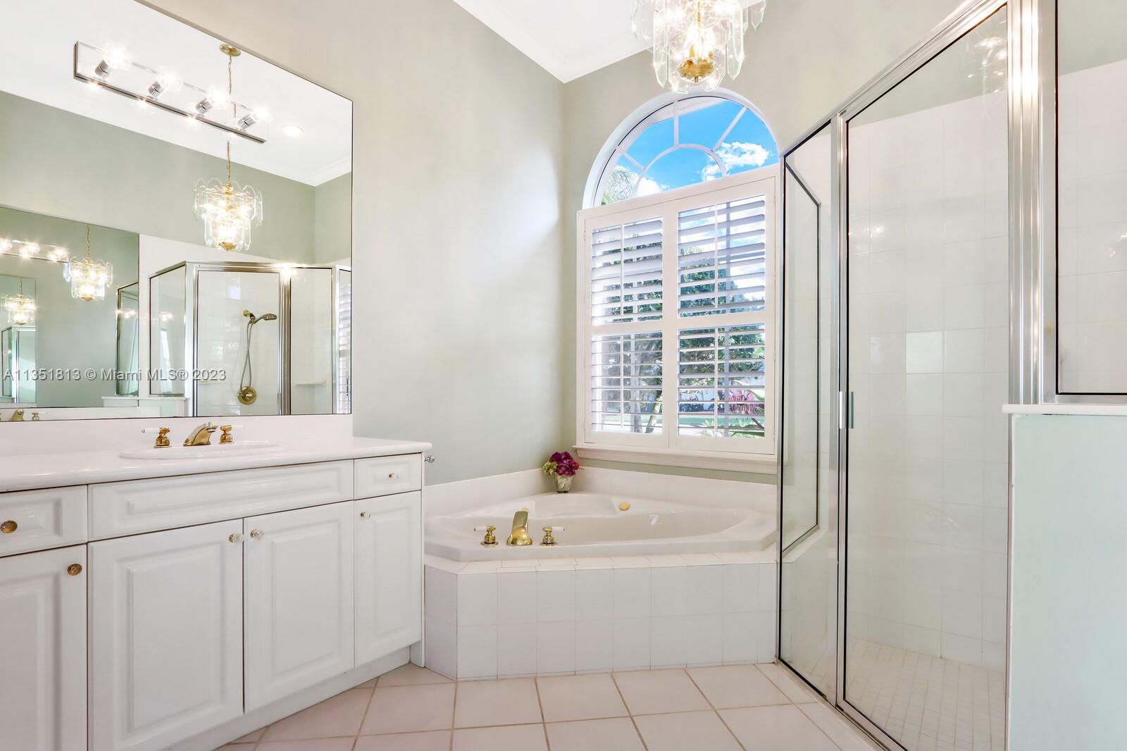 1237 Southwest Blue Stem Way Stuart, FL 34997 - Photo 25 of 48 a bathroom with a tub sink and mirror
