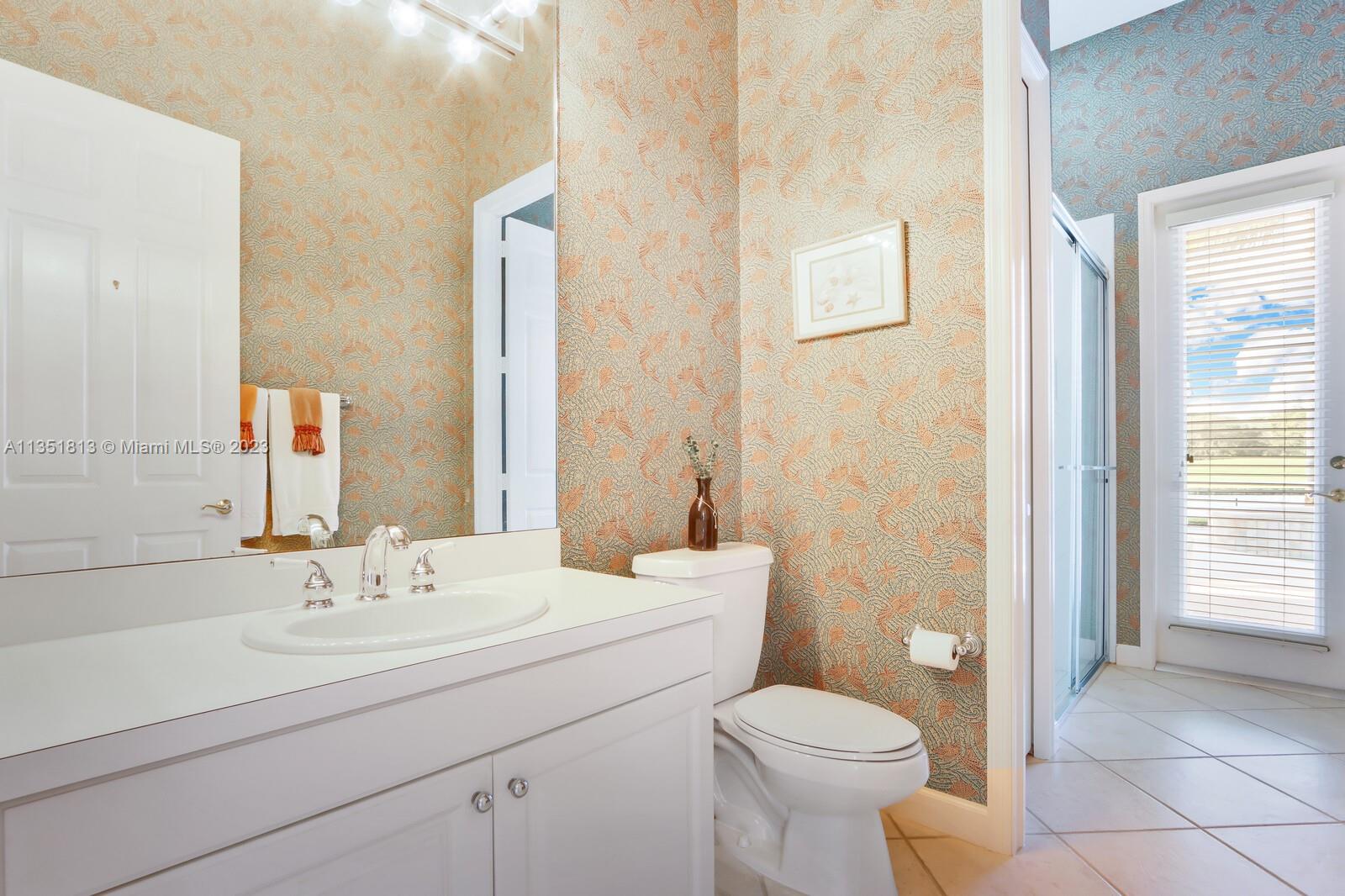 1237 Southwest Blue Stem Way Stuart, FL 34997 - Photo 27 of 48 a bathroom with a sink a toilet and shower