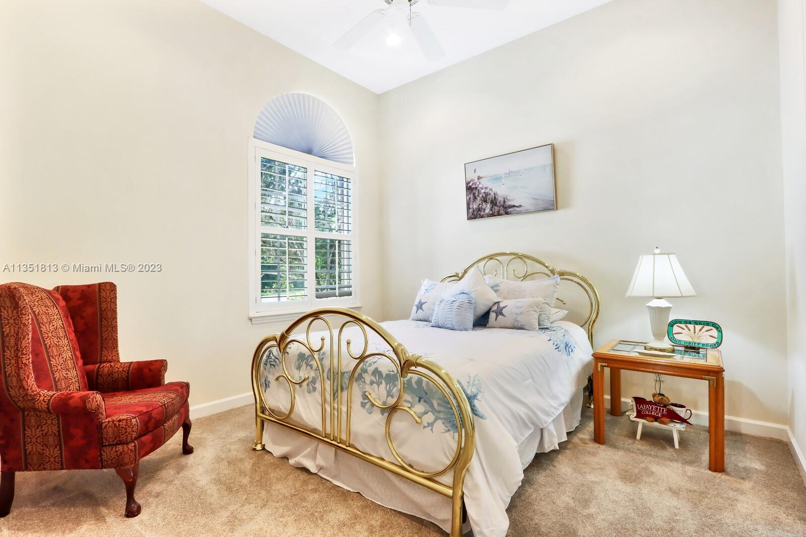 1237 Southwest Blue Stem Way Stuart, FL 34997 - Photo 28 of 48 a bedroom with a bed and a couch