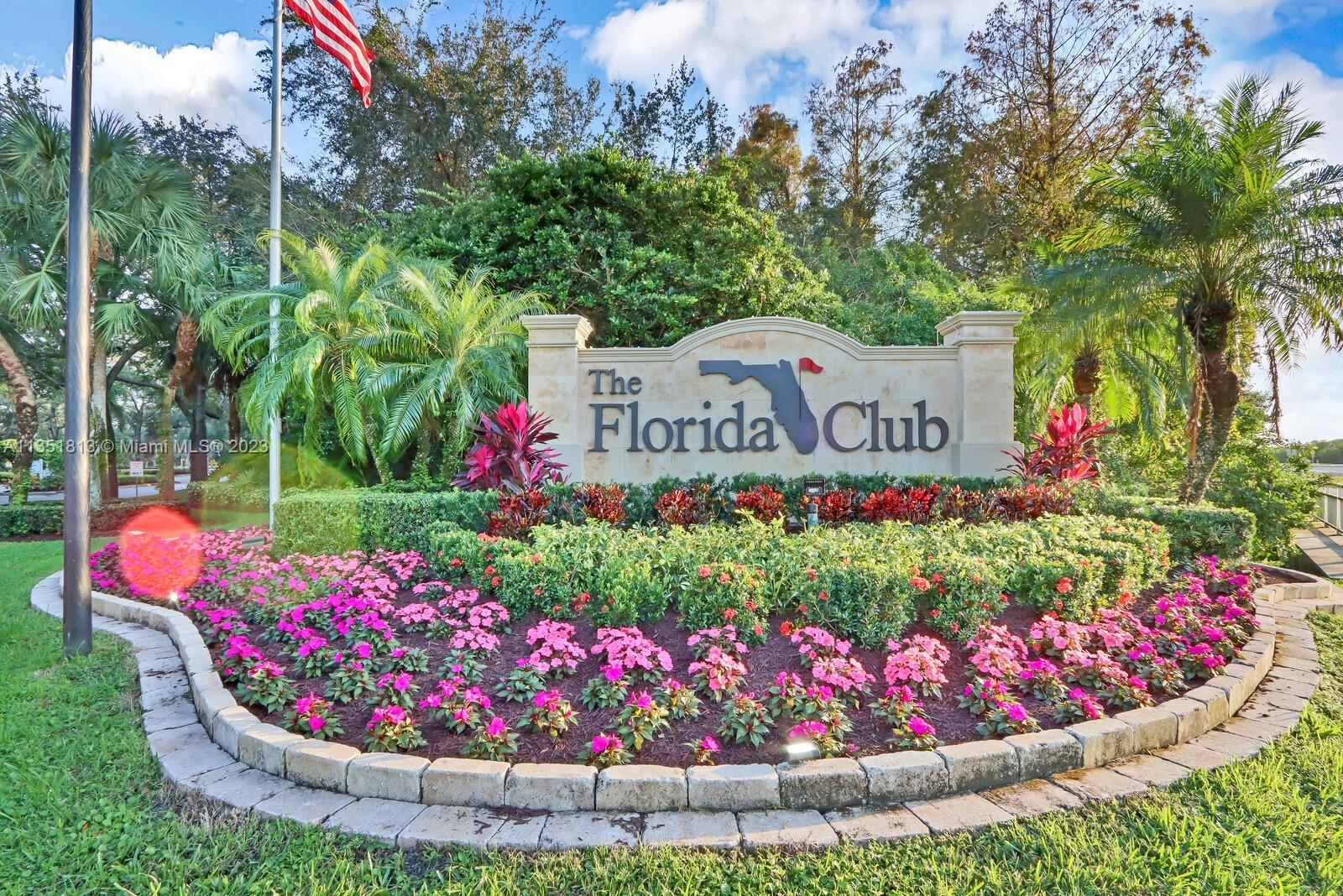 1237 Southwest Blue Stem Way Stuart, FL 34997 - Photo 3 of 48 a view of sign board with flower in pots