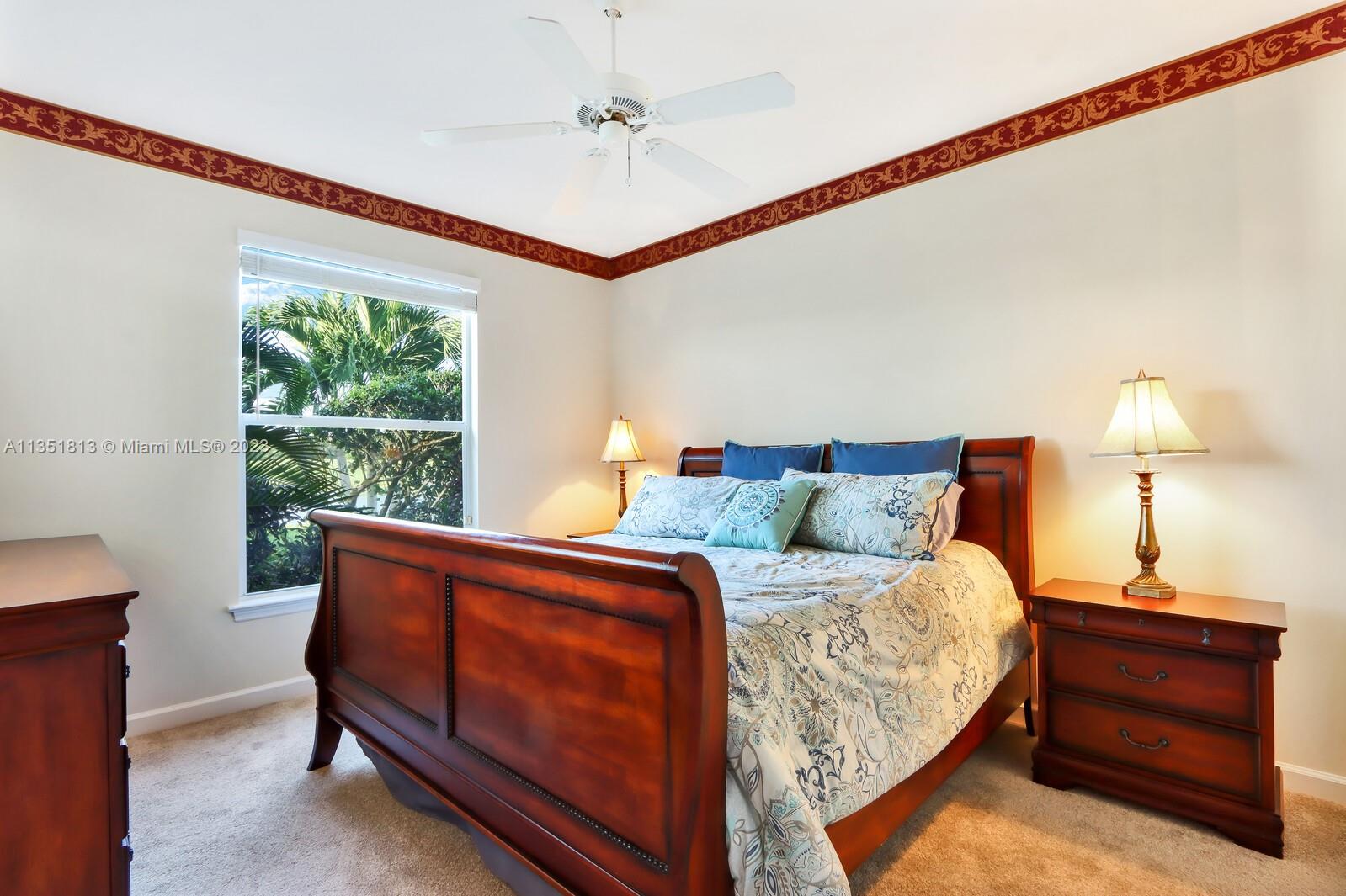 1237 Southwest Blue Stem Way Stuart, FL 34997 - Photo 31 of 48 a bedroom with a bed and a dresser next to a window