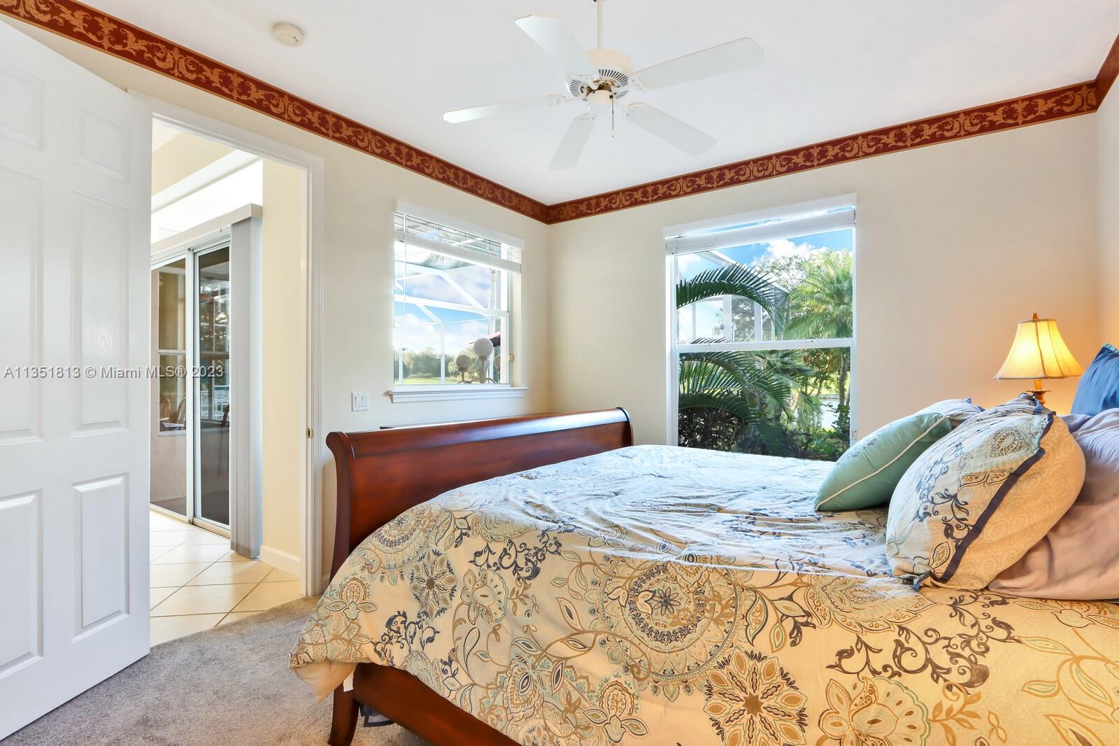 1237 Southwest Blue Stem Way Stuart, FL 34997 - Photo 32 of 48 a bed sitting in a bedroom next to a window