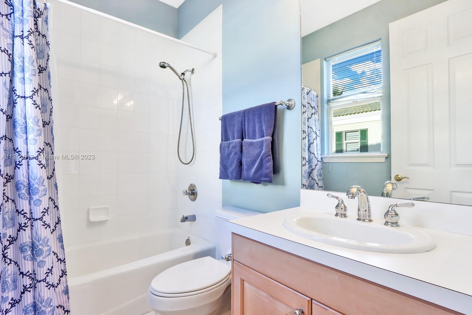 1237 Southwest Blue Stem Way Stuart, FL 34997 - Photo 33 of 48 a bathroom with a granite countertop sink toilet tub and shower