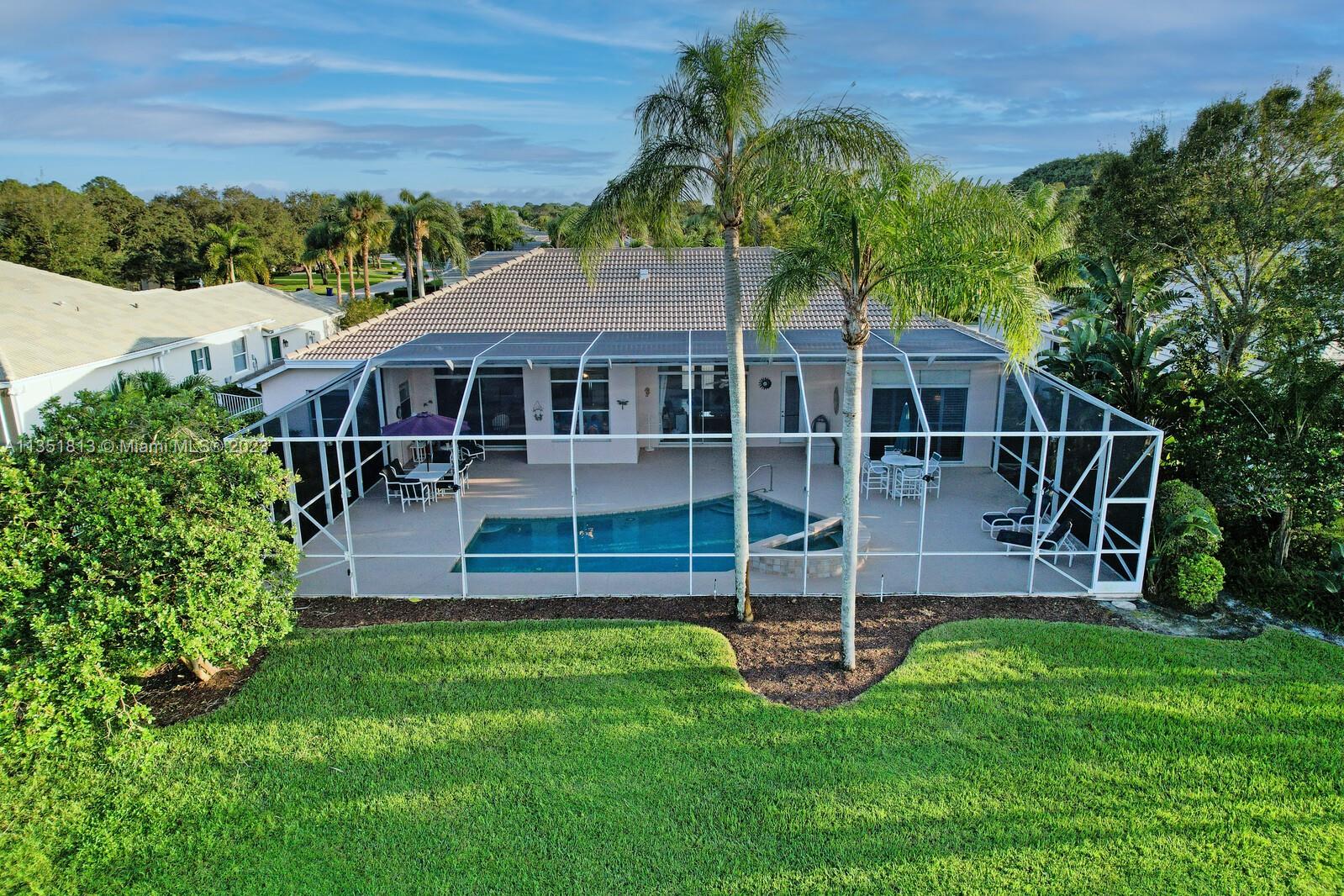 1237 Southwest Blue Stem Way Stuart, FL 34997 - Photo 44 of 48 a view of a house with a yard deck and a garden