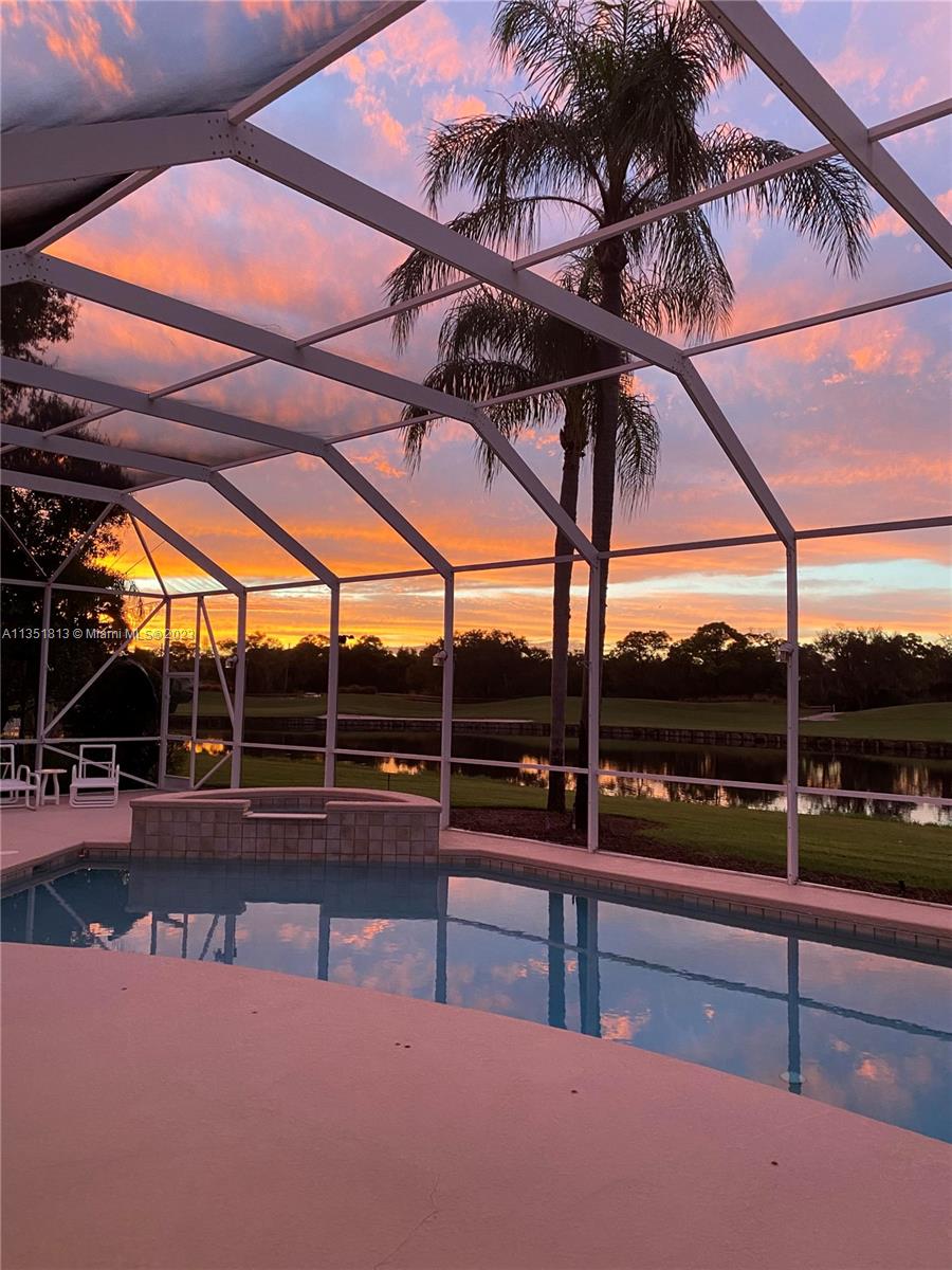 1237 Southwest Blue Stem Way Stuart, FL 34997 - Photo 5 of 48 a view of a swimming pool with a bench