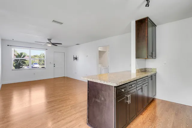 a kitchen with stainless steel appliances granite countertop a sink a stove and a refrigerator