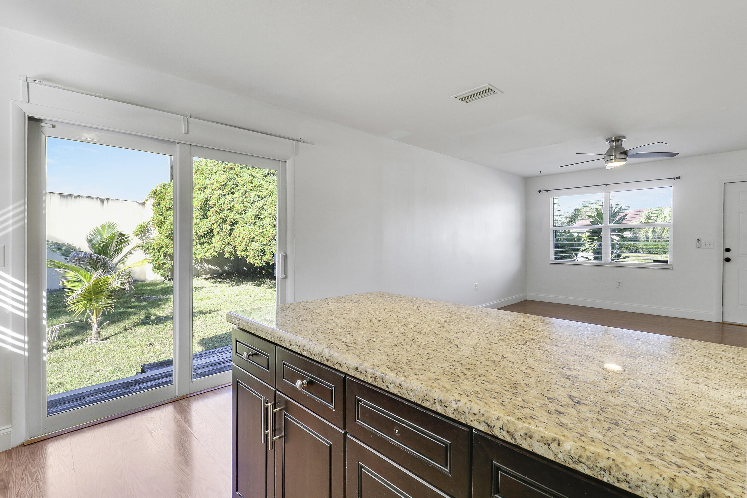 6264 Allen Street Jupiter, FL 33458 - Photo 14 of 27 a view of kitchen with granite countertop cabinets and outdoor space