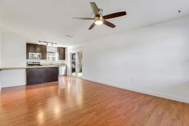 a kitchen with stainless steel appliances kitchen island granite countertop a stove top oven and sink