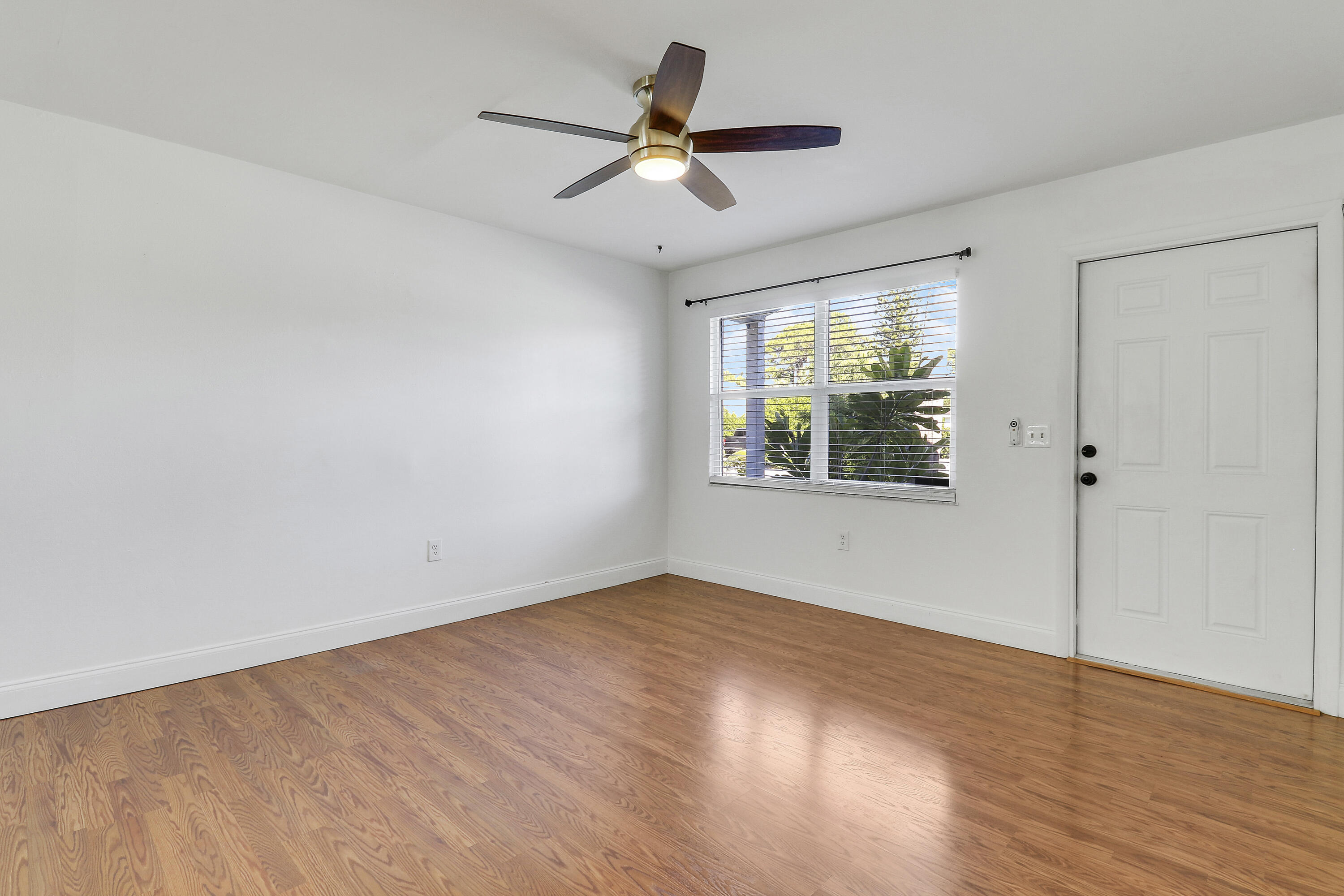 6264 Allen Street Jupiter, FL 33458 - Photo 18 of 27 wooden floor in an empty room with a window