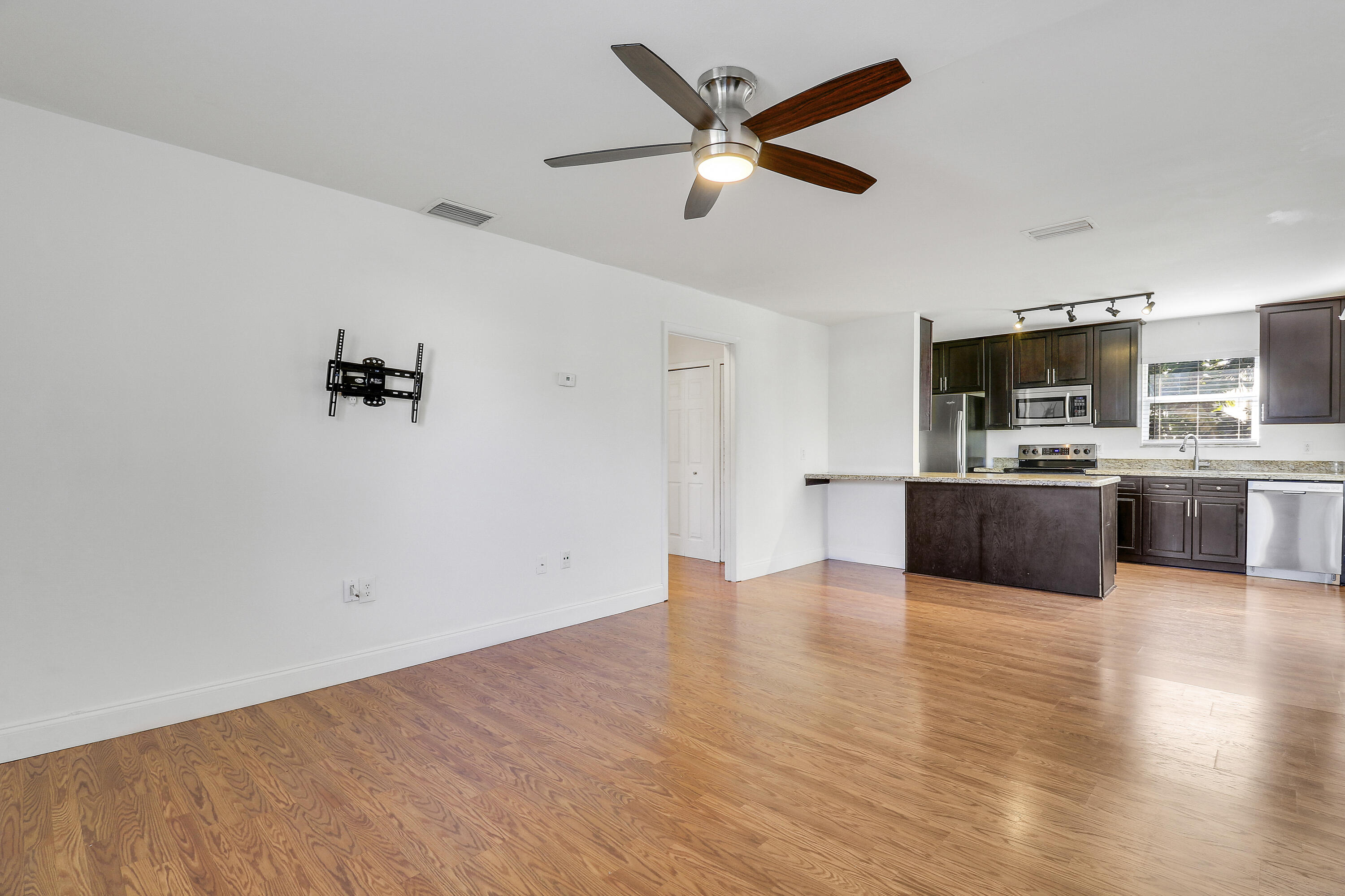 6264 Allen Street Jupiter, FL 33458 - Photo 7 of 27 a view of a kitchen with microwave and cabinets