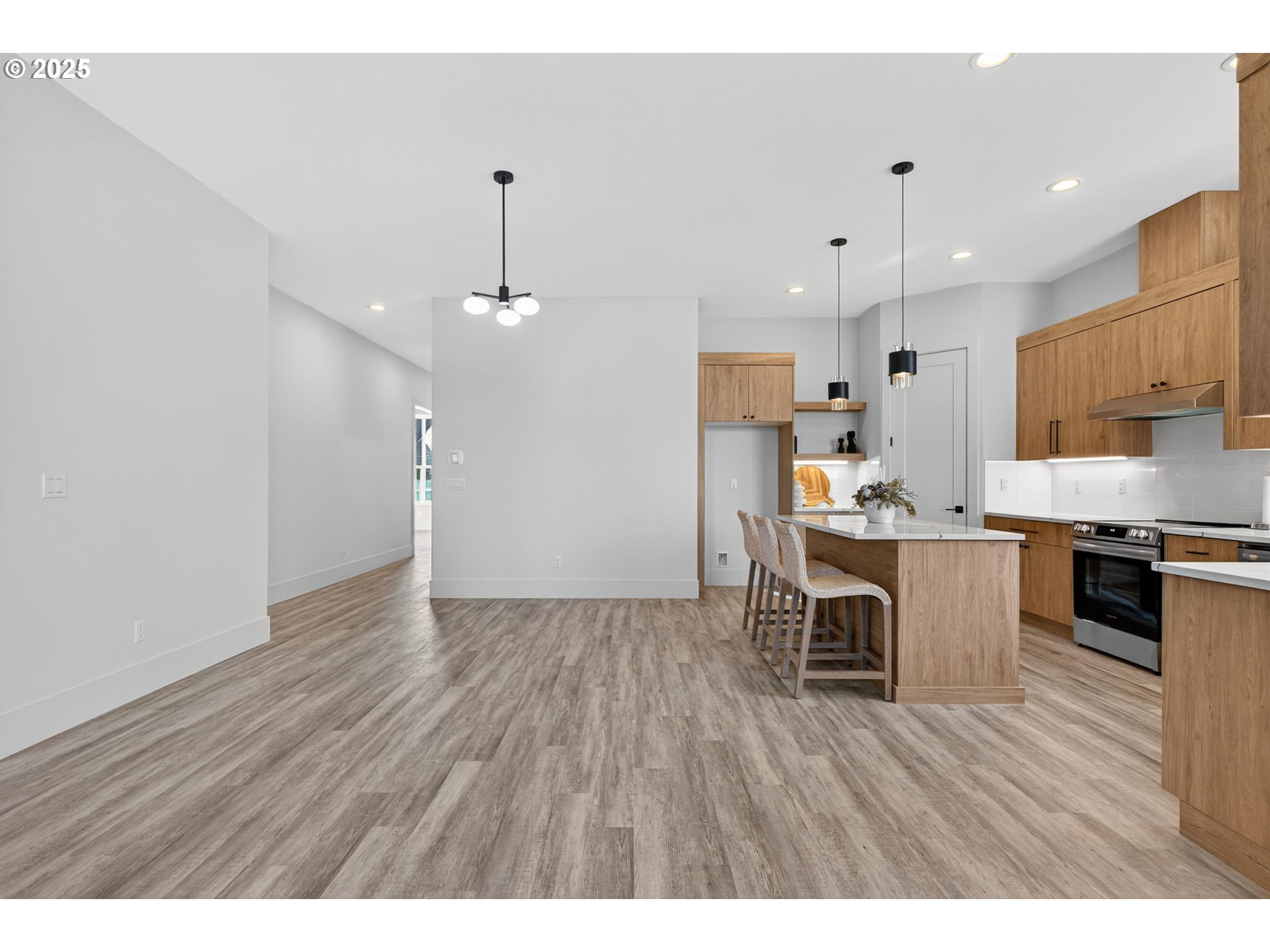 632 Southeast 35th Street Battle Ground, WA 98604 - Photo 16 of 34 a open kitchen with stainless steel appliances granite countertop a stove top oven a sink dishwasher and white cabinets with wooden floor
