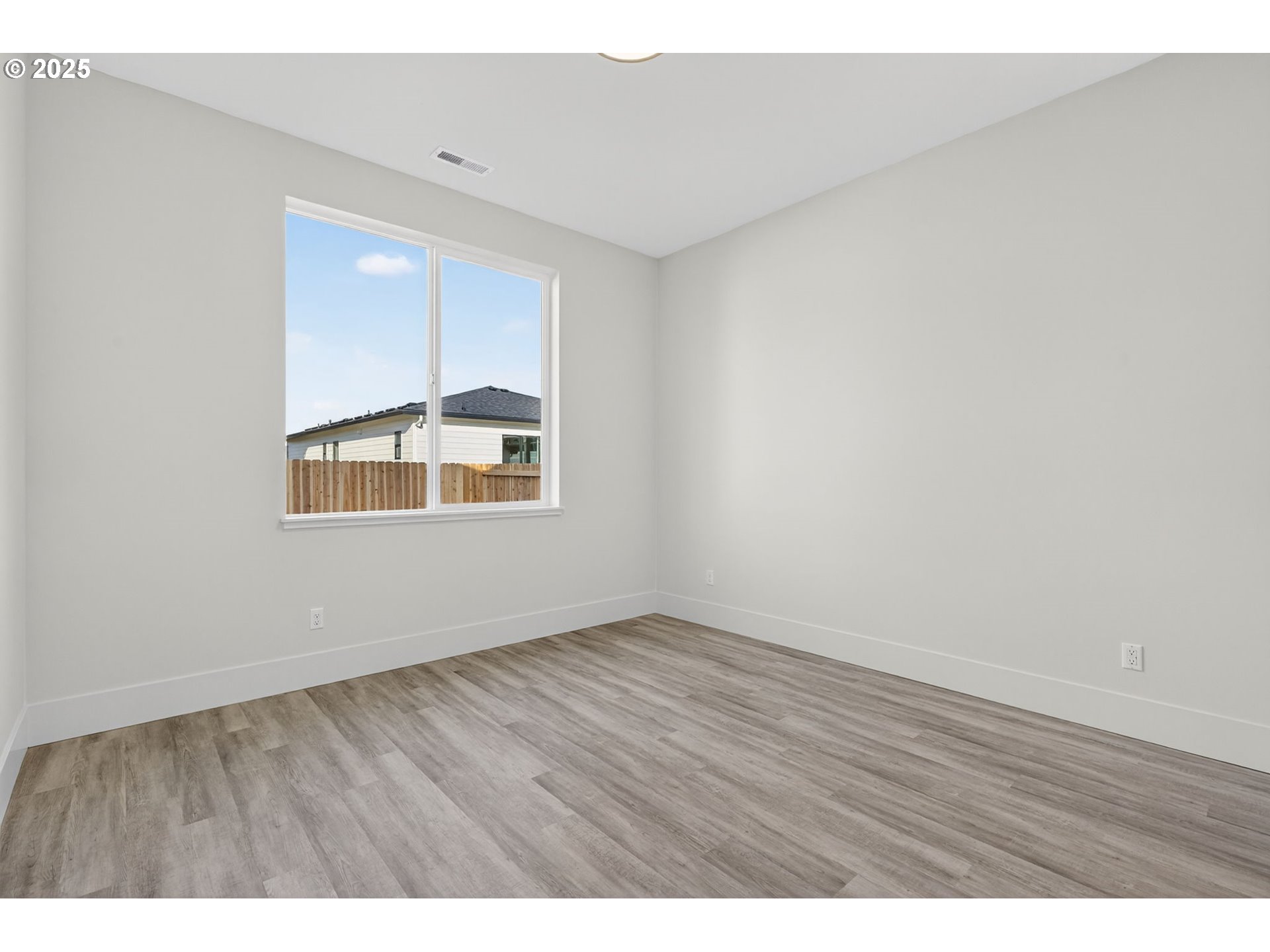 632 Southeast 35th Street Battle Ground, WA 98604 - Photo 17 of 34 a view of an empty room with wooden floor and a window