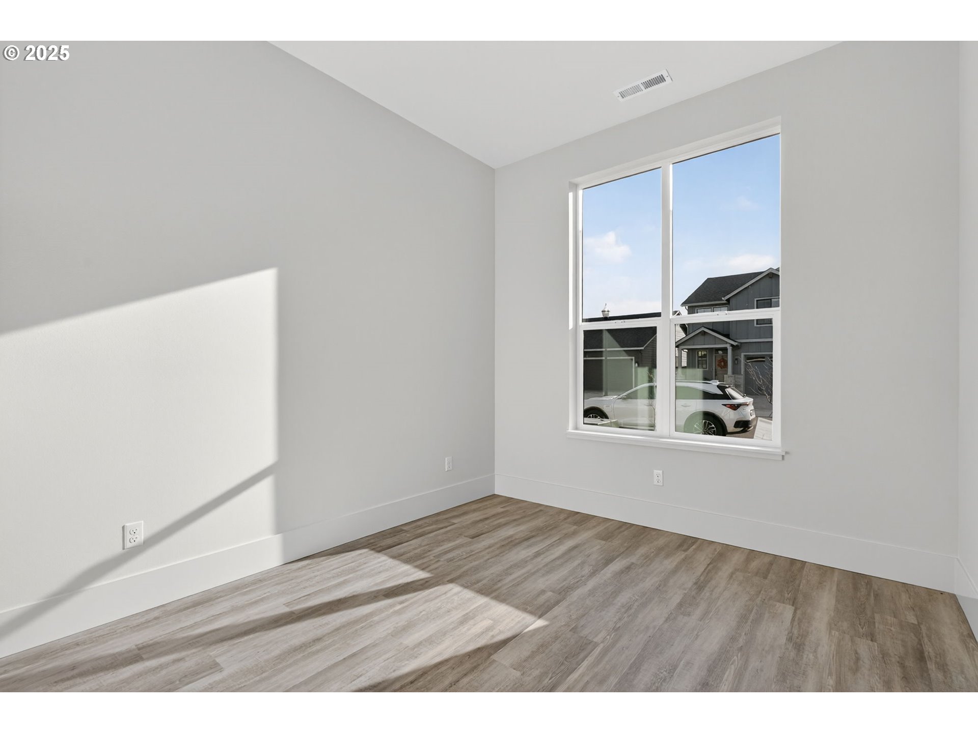 632 Southeast 35th Street Battle Ground, WA 98604 - Photo 24 of 34 a view of an empty room with wooden floor and a window