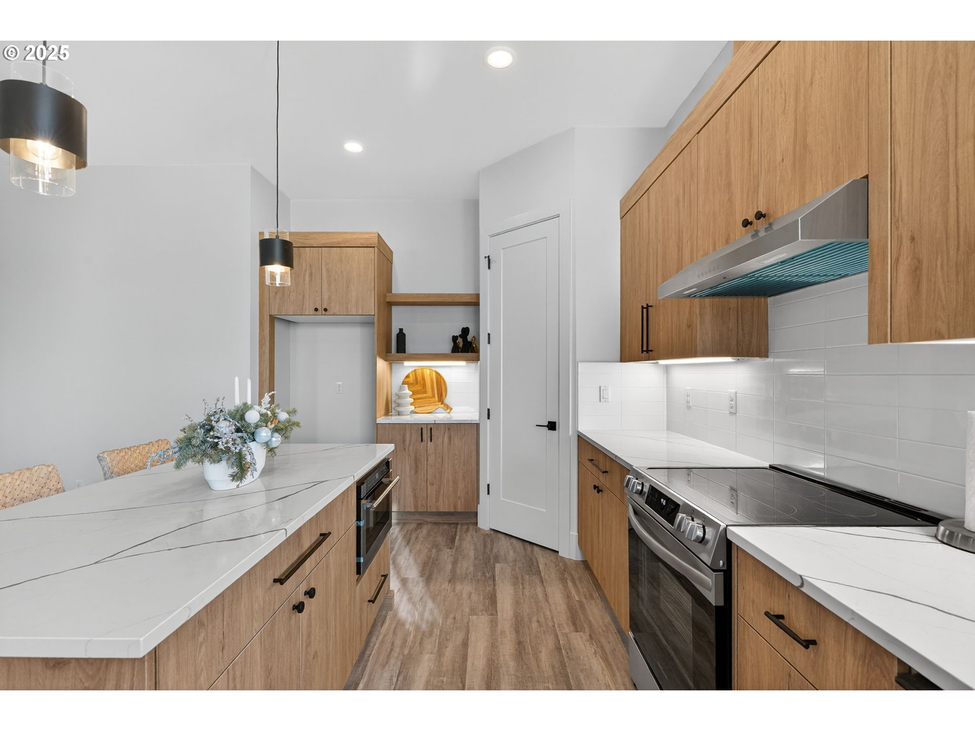 632 Southeast 35th Street Battle Ground, WA 98604 - Photo 7 of 34 a kitchen with a sink dishwasher a stove a dining table and chairs with wooden floor