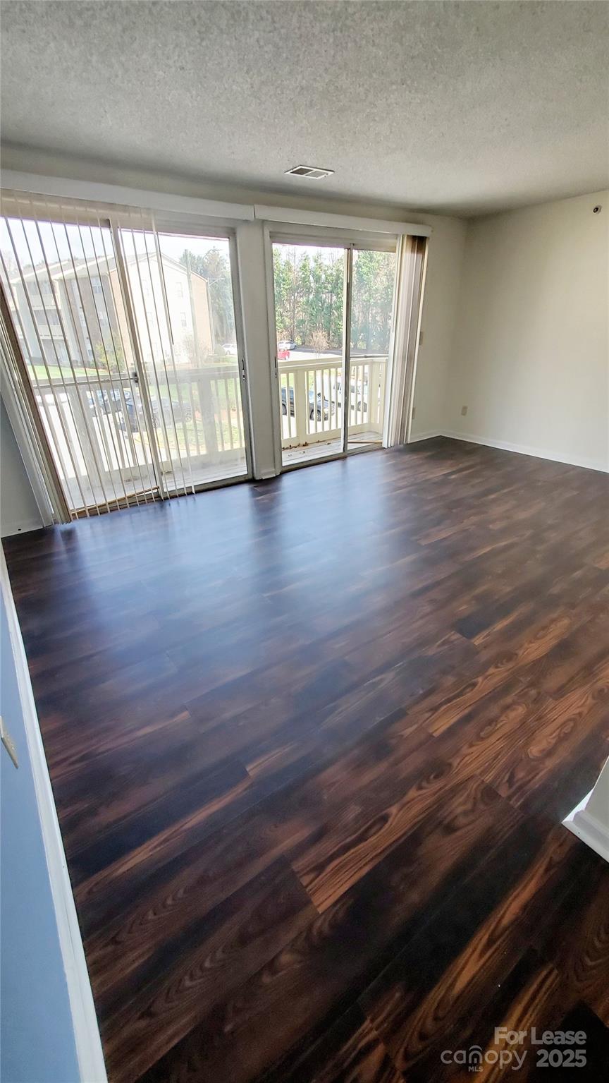 1610 Arlyn Circle Charlotte, NC 28213 - Photo 18 of 25 a view of an empty room with wooden floor and a window