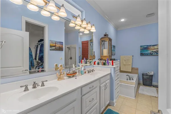 a spacious en suite bathroom with a double vanity sink and a mirror