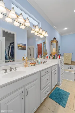 a spacious bathroom with a sink vanity and mirror