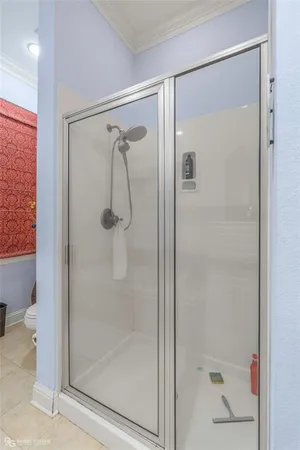 a bathroom with a glass shower door