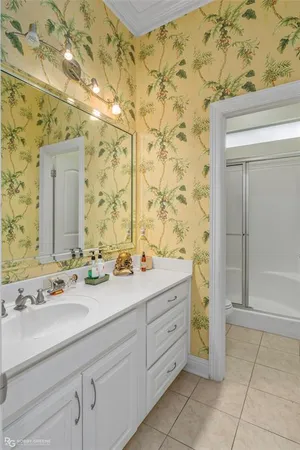 a bathroom with a sink a mirror and a shower