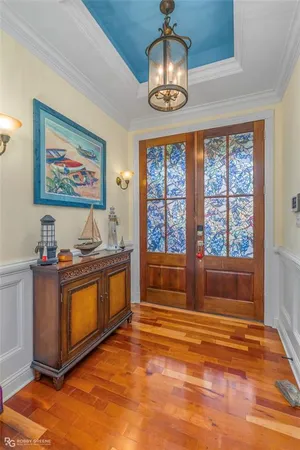 a view of spacious bedroom with a bed and a chandelier fan