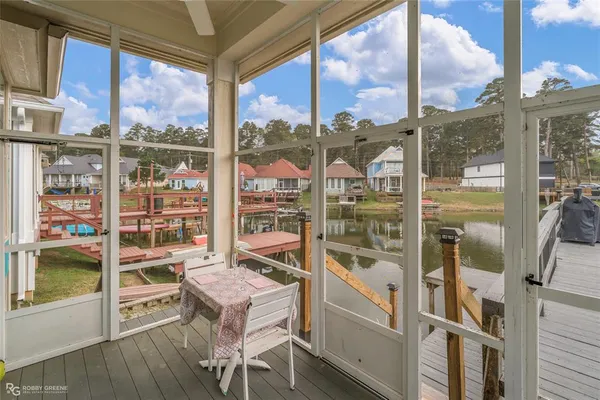 a view of a room with a large window and furniture