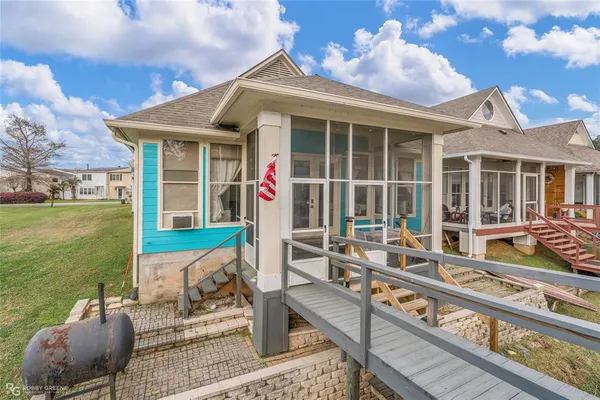 a house view with a sitting space and garden