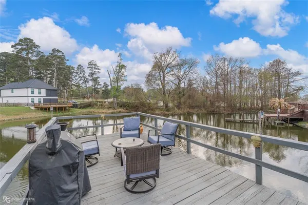a view of a lake with table and chairs