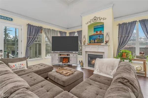 a living room with furniture a fireplace and a flat screen tv