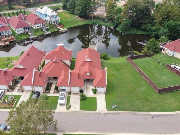 an aerial view of residential house with outdoor space and lake view