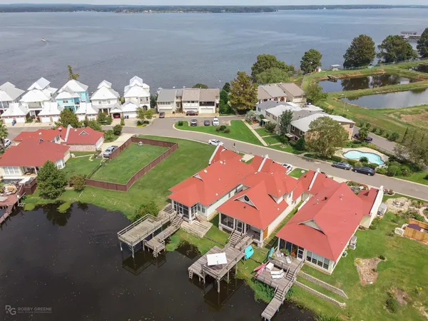 an aerial view of a house with yard swimming pool and outdoor seating
