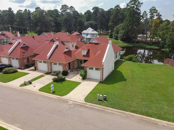 an aerial view of a house with garden space and street view