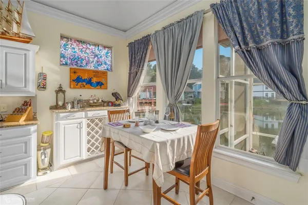 a dining room with furniture and a floor to ceiling window