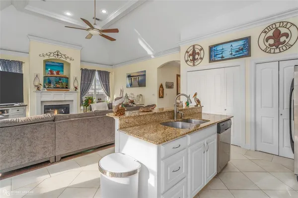 a kitchen with a sink cabinets and wooden floor