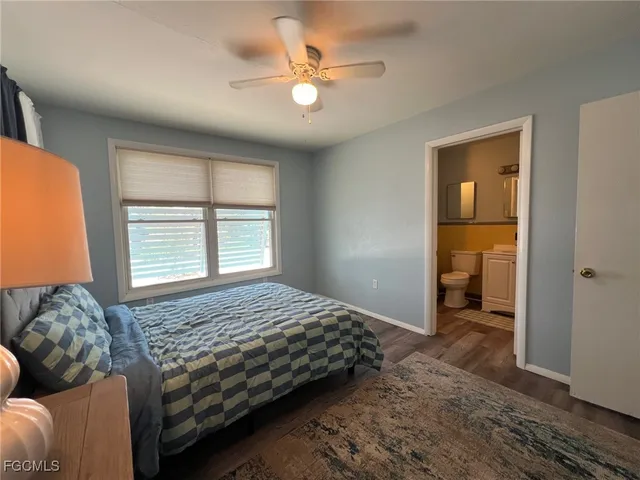 a bedroom with a bed and a large window with the outer view