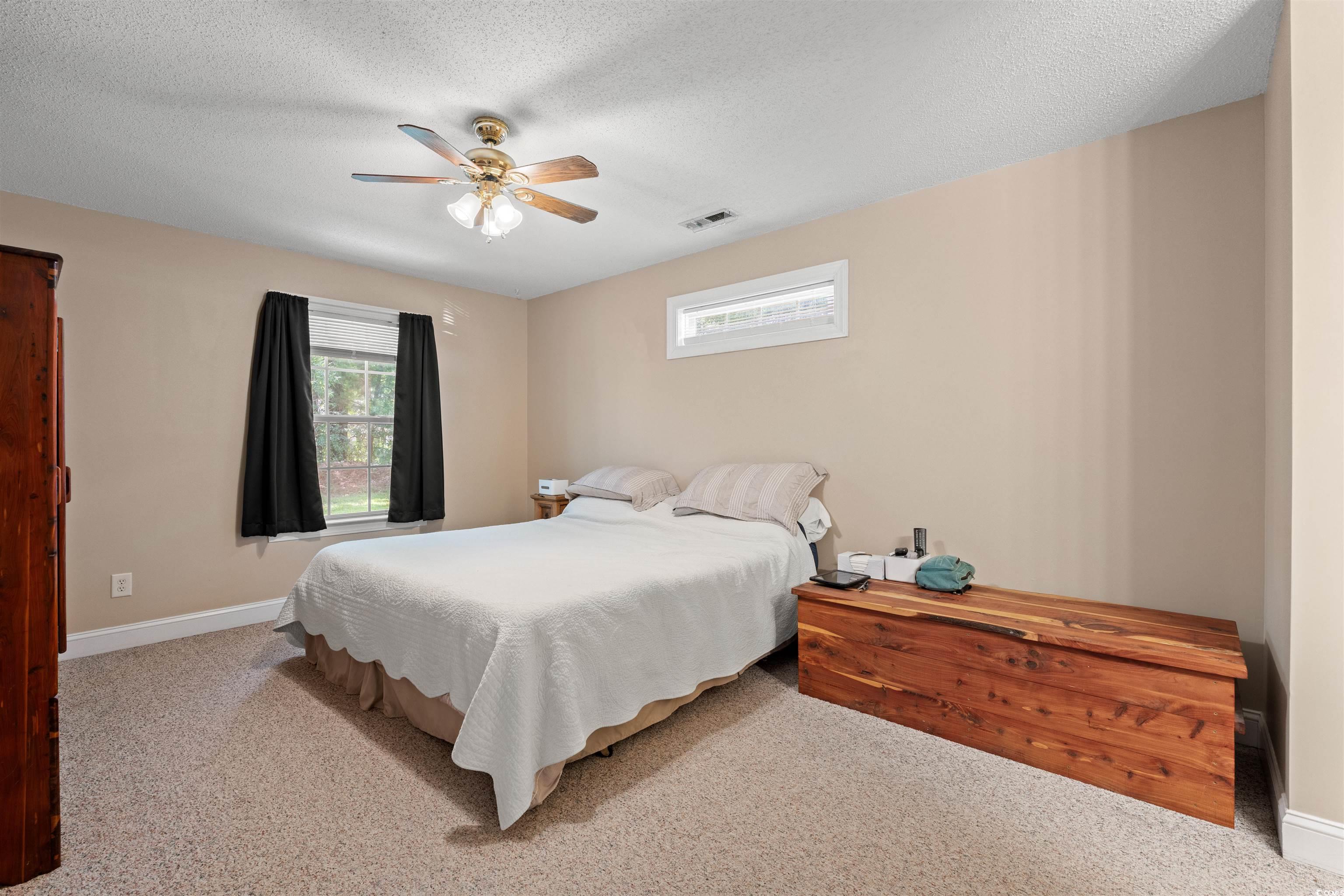 938 Fox Hollow Road Conway, SC 29526 - Photo 10 of 39 Bedroom featuring carpet flooring, ceiling fan, and a textured ceiling