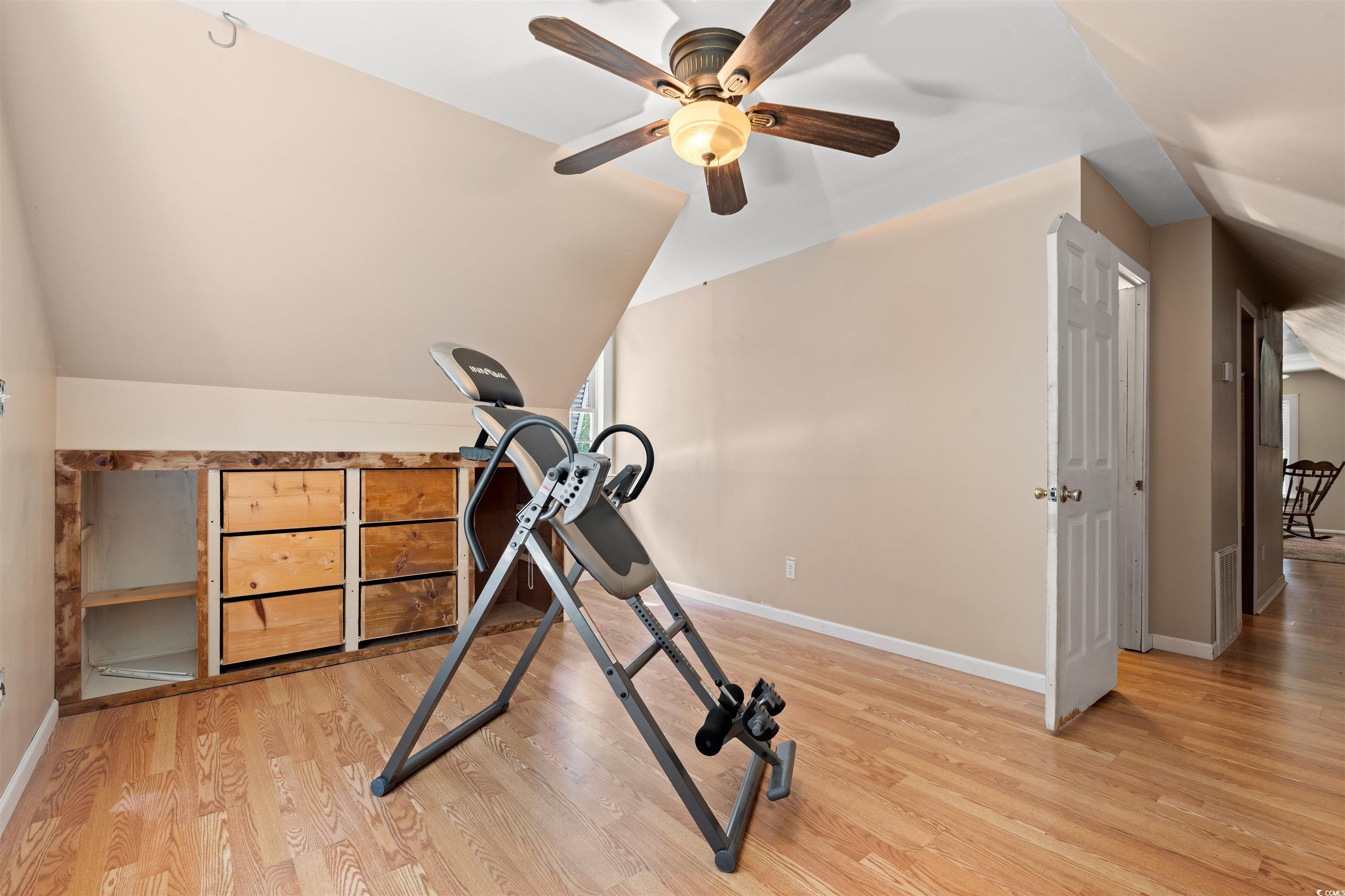 938 Fox Hollow Road Conway, SC 29526 - Photo 16 of 39 Workout area with ceiling fan, wood finished floors, and vaulted ceiling
